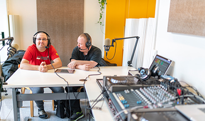 Kaksi ihmistä äänittää radio-ohjelmaa.
Kuvaaja: Pasi Markkanen, Suomi-kuvapankki